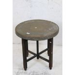 Eastern Brass Tray Top Table raised on a wooden folding base, 60cm diameter