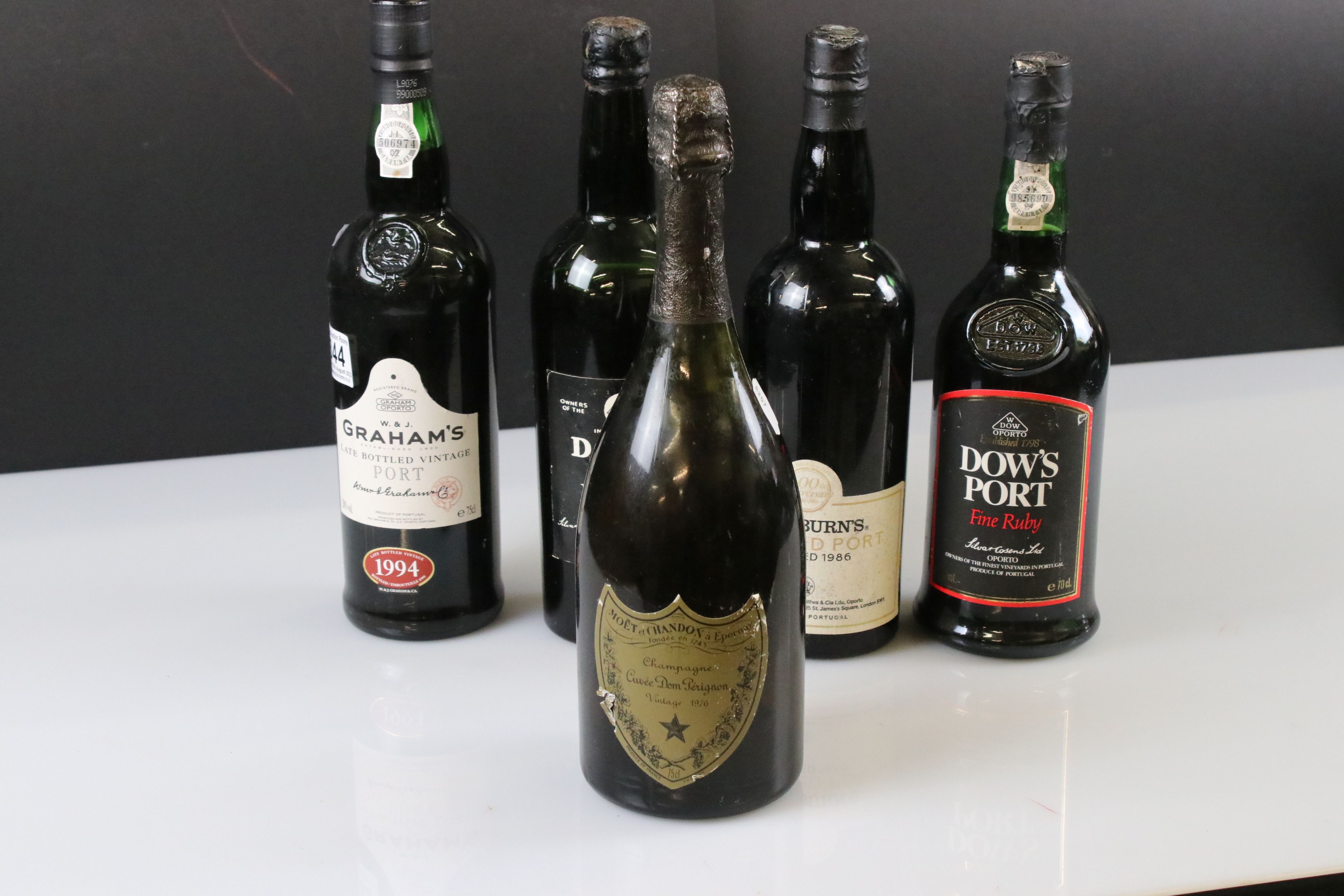 A collection of four bottles of Port to include Dow's and Cockburns together with a bottle of 1976