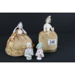 A collection of four antique ceramic pin cushion dolls.