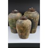 Three Weathered Terracotta Urns with Metal Lids, tallest 40cm