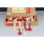 An antique carved bone red and white chess set in the style of Staunton.