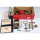 A box of mixed collectables to include silk postcards, button hooks, magnifying glass, crucifix...