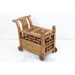 Chinese Hardwood Drink Trolley with geometric pierced sliding top opening to eight bottle spaces, on