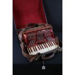 Mid 20th Century red piano accordion with leather strap, in wooden case (the accordion measures