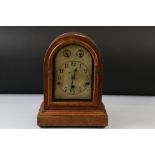 A German domed wooden cased chiming mantle clock with silvered dial, complete with key.