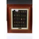 Framed collection of 35 advertising pocket watch keys