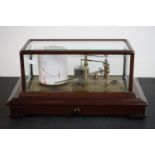 An antique Negretti & Zambra of London barograph with mahogany and bevelled glass case.