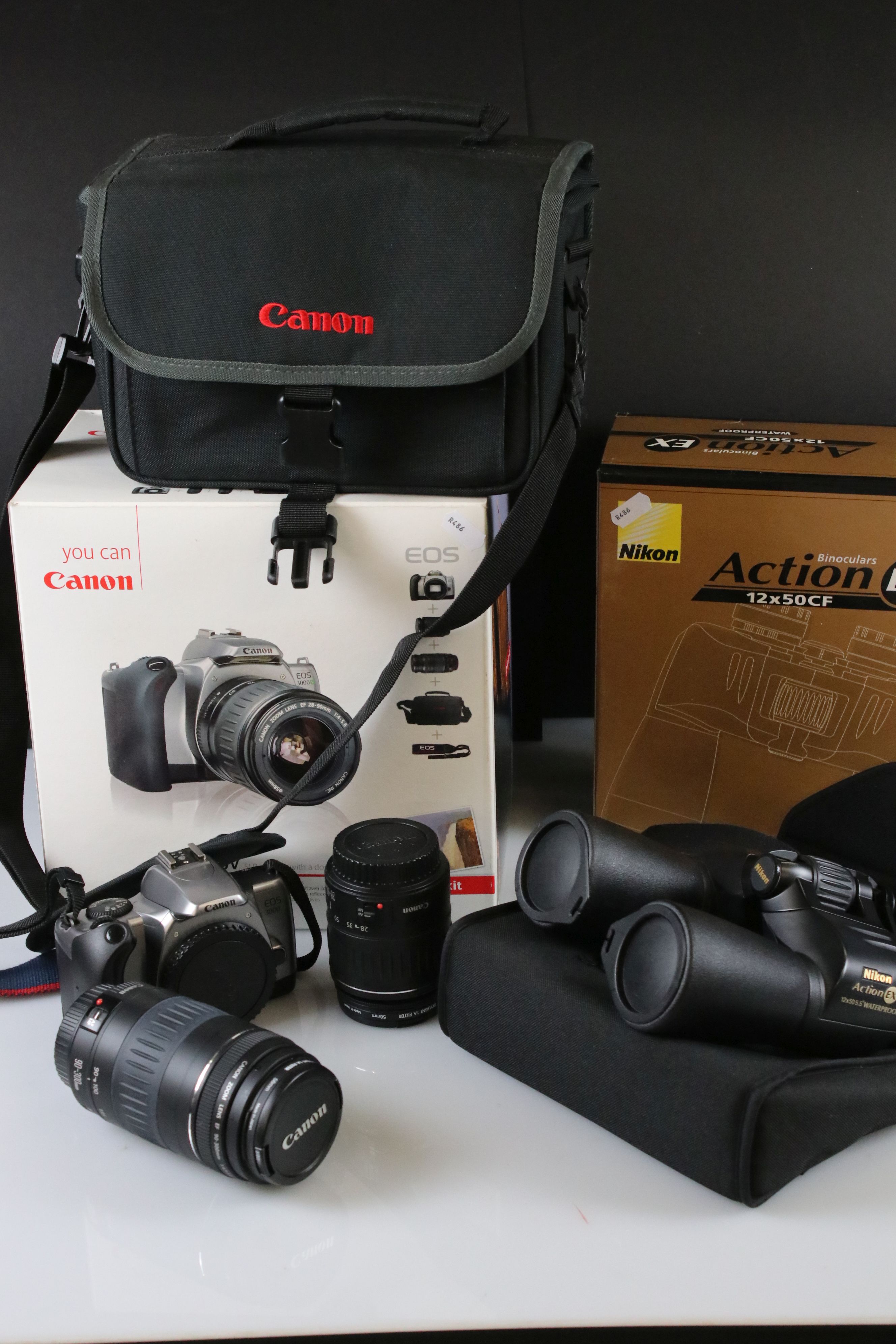 A Canon Eos 3000 35mm SLR camera complete with lenses and accessories.