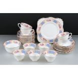 Early 20th century Tuscan China Part Tea Service decorated with flowers and blue floral panels