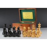 A Staunton boxwood and ebony chess set with weighted bases in original velvet lined box.