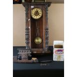 A vintage wooden cased Vienna style wall clock.