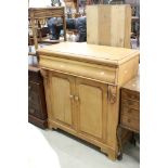 19th century Pine Dresser Base comprising cushion drawer over two cupboard doors, 90cm wide x 44cm