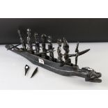 African ebonized wood carving of a native boat with seven figures
