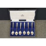 Six enamelled silver gilt demitasse spoons, the bowls with white enamel decorated with fruit and