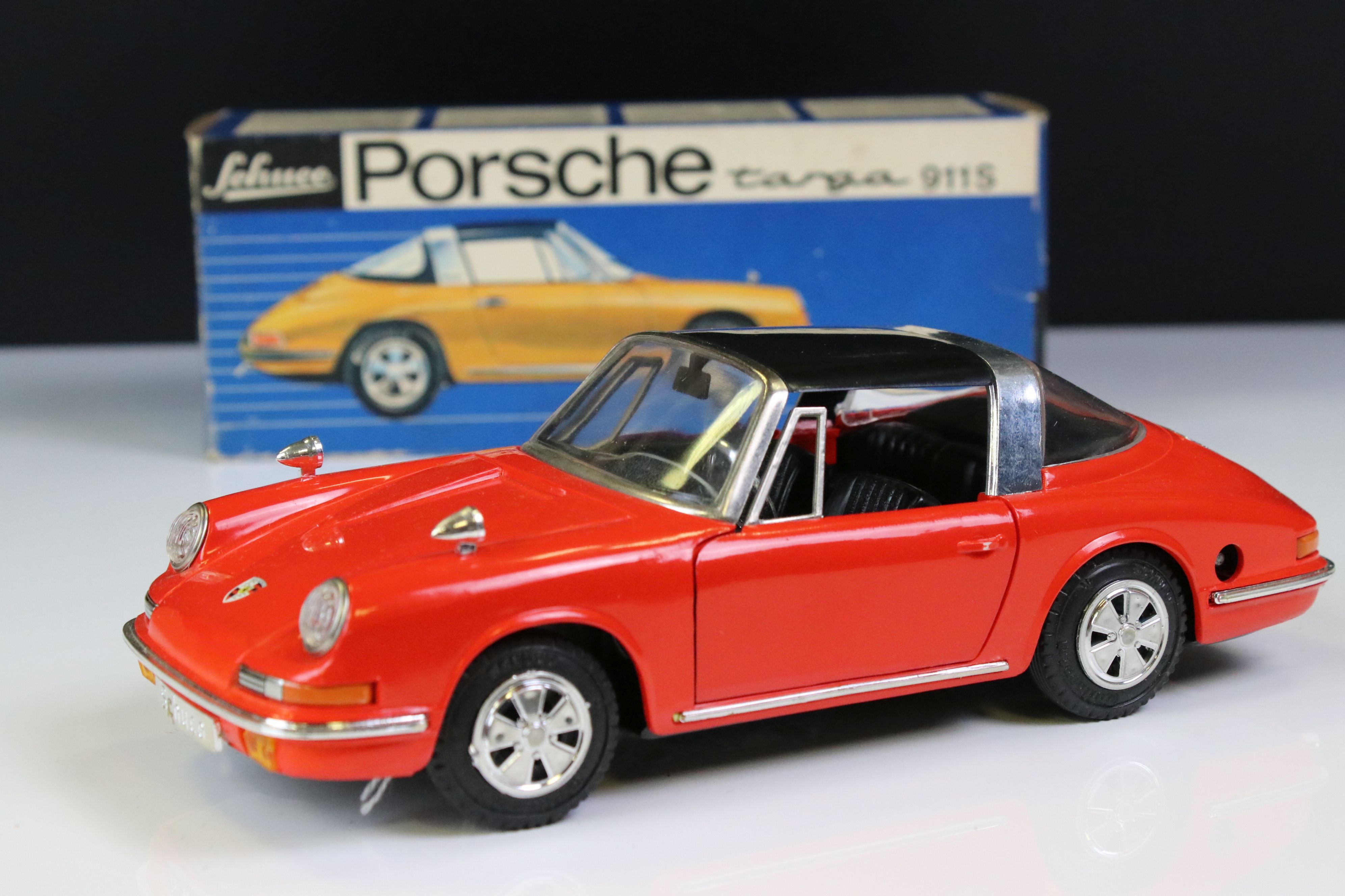 Boxed Schuco clockwork Porsche Targa 911S in red with black roof, vg condition with only minor paint