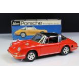 Boxed Schuco clockwork Porsche Targa 911S in red with black roof, vg condition with only minor paint