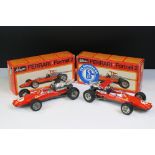 Two boxed Schuco Formel 2 models, both in red and with keys, one missing rear spoiler, one with FC