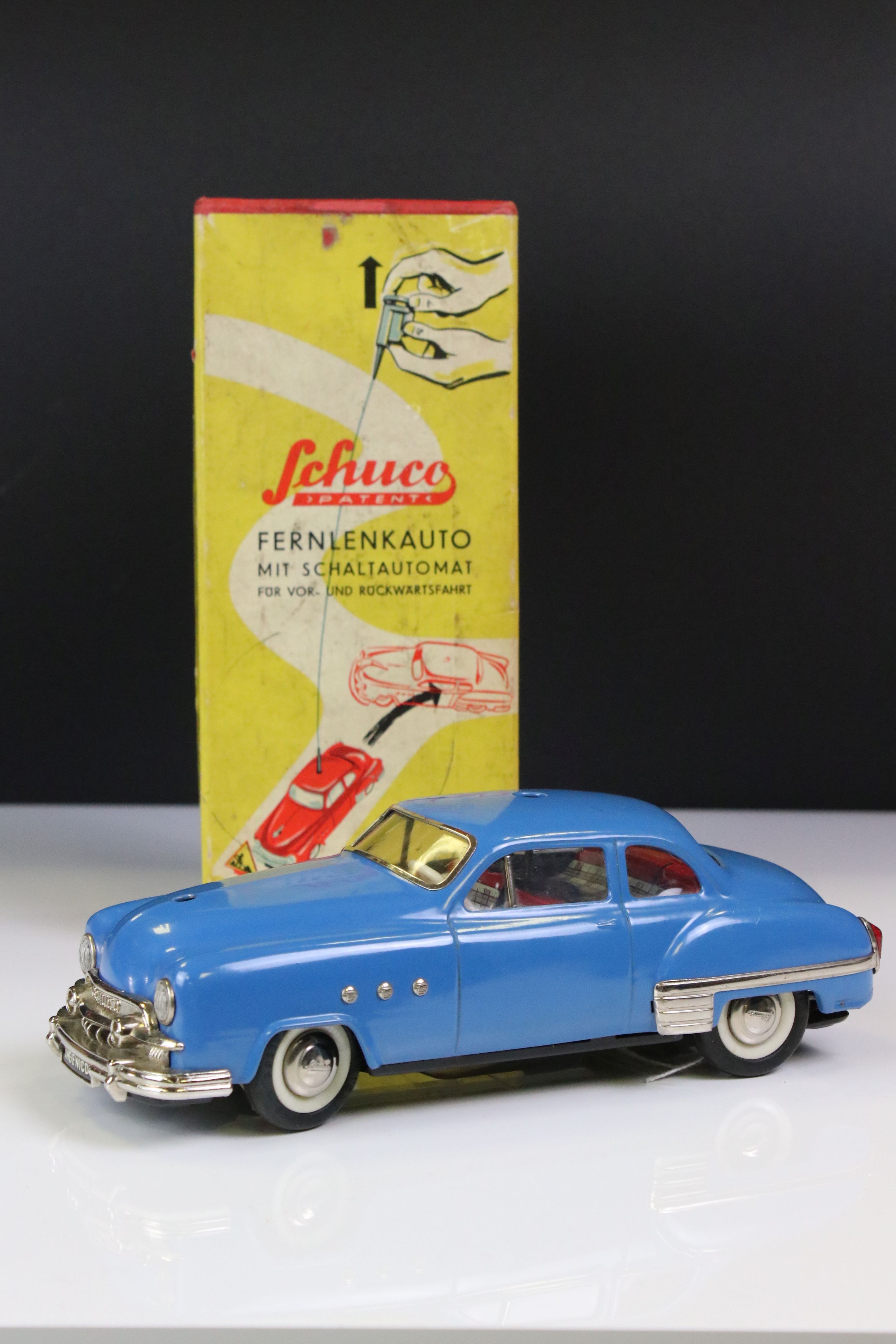 Boxed Schuco 5301 Fernlenkauto Ingenico tin plate clockwork car in blue, chassis loose from body,