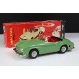 Boxed Schuco 2095 Mercedes 190SL tin plate clockwork car in green with red interior, complete with