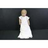 Vintage fabric-covered baby doll dressed in a christening robe, with painted facial features, approx