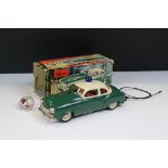 Schuco battery powered tin plate Alarm Police Car 5340 in green with cream roof and blue light, with