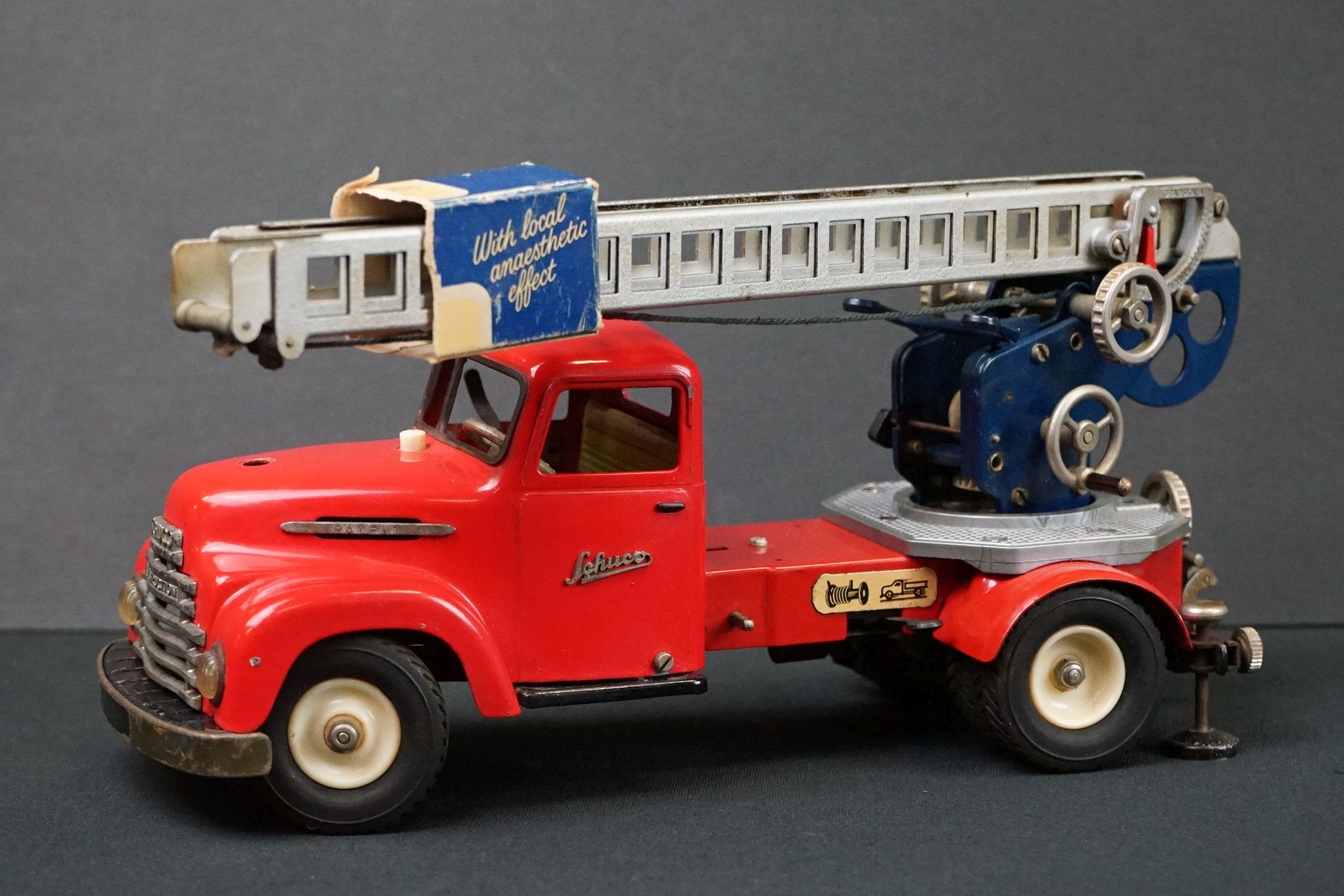 Original tin plate Schuco Pracision electro construction fire engine model in red, with extending