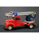 Original tin plate Schuco Pracision electro construction fire engine model in red, with extending