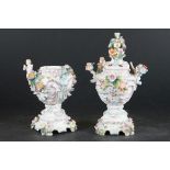 Pair of Continental Porcelain Floral and Cherub Encrusted Lidded Jars, blue anchor marks to base,