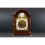A Comitti of London mantle clock with Roman numeral hour markers, marked 'Tempus Fugit' to the
