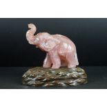 Carved Rose Quartz Elephant on a Wooden Stand, total height 18cm