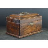An antique wooden lidded box with brass fittings