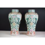 Pair of Chinese Famille Verte vases decorated with dragons & foliage