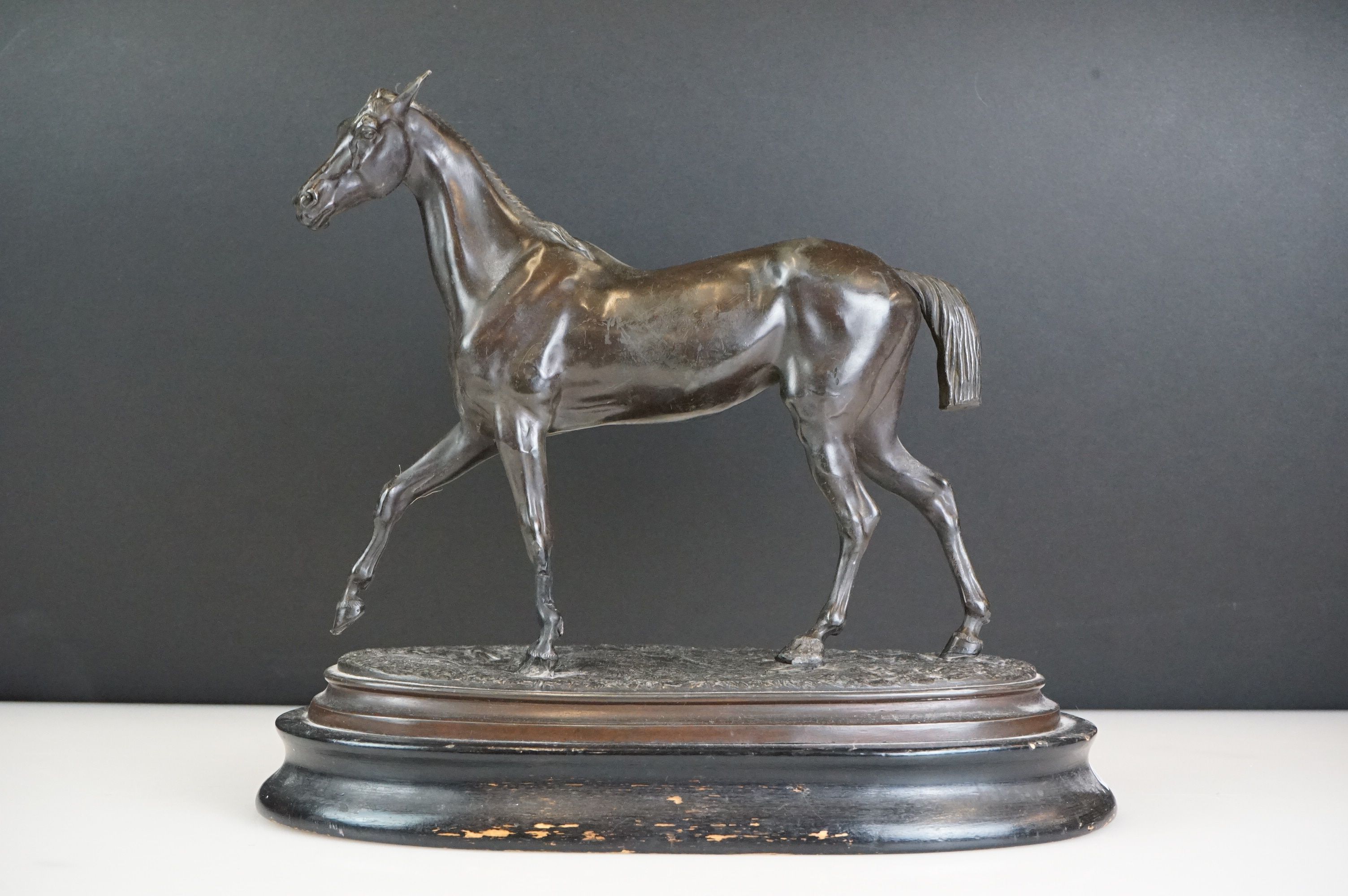 Spelter figure of a horse mid-stride, mounted on a wooden base, approx 27cm high