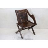 Early 20th century Oak Glastonbury Chair carved with flowers and leaves, 65cm wide x 92cm high