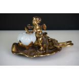 19th Century gilt metal desk inkwell modelled as a cherub on a lily pad, the cherub rotates to allow