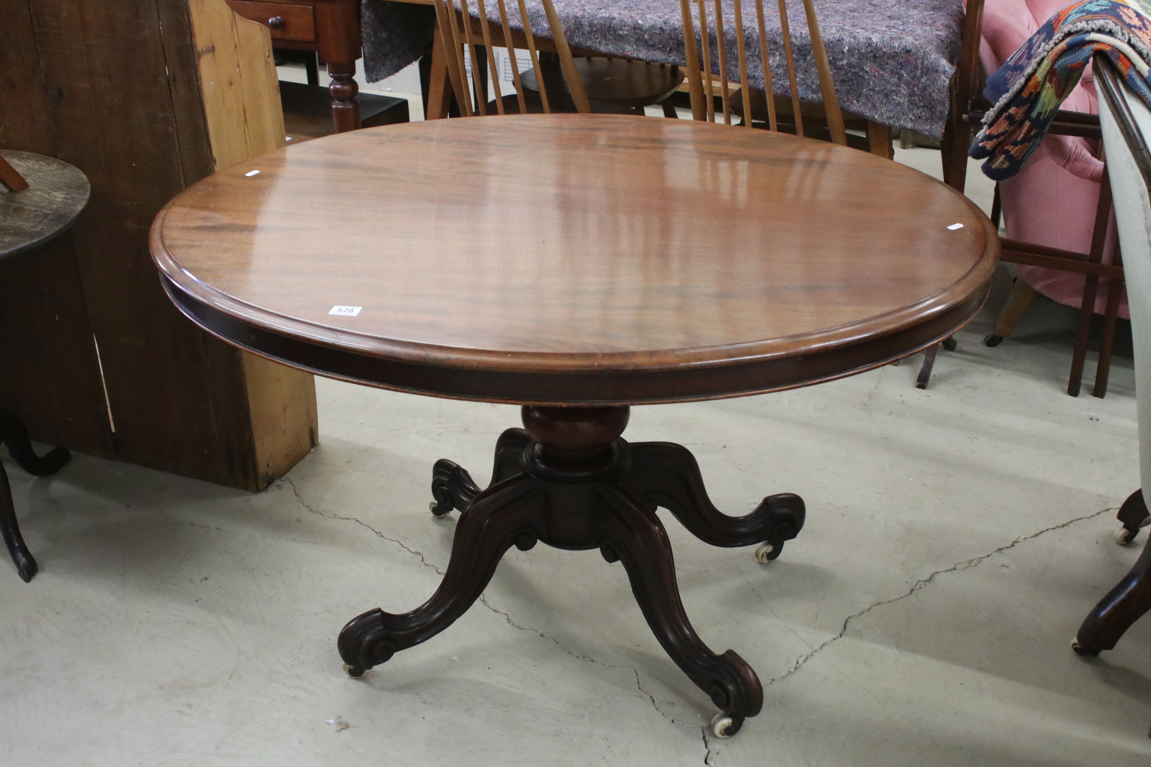 Victorian Mahogany Oval Tilt Top Breakfast Table on bulbous pedestal and four carved scrolling