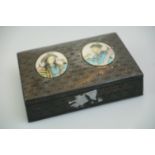 An antique Persian metal table top cigarette box with two hand painted figural panels.