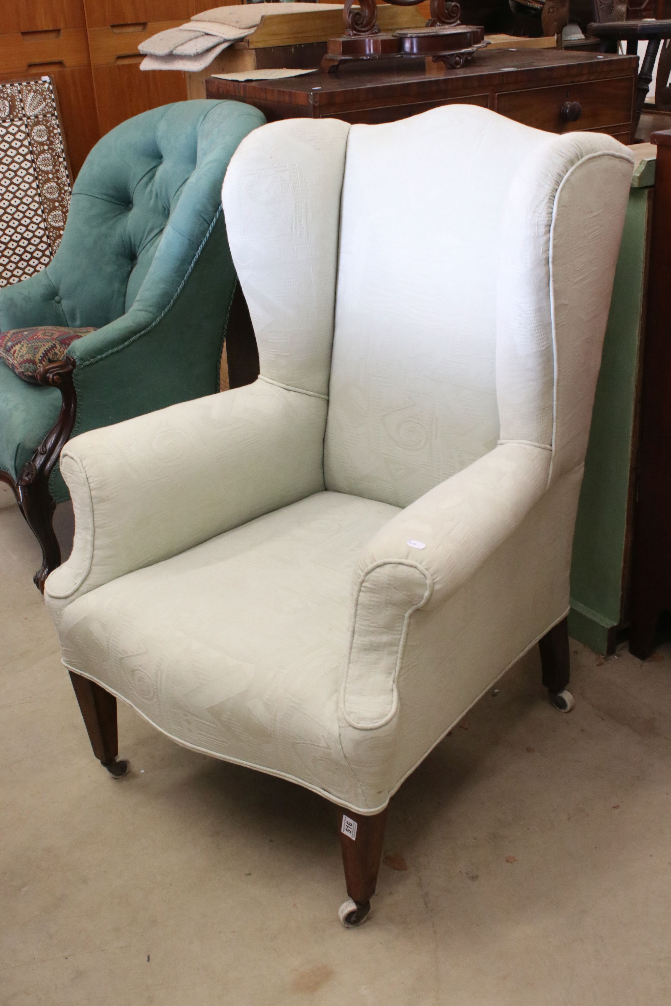 Late 19th / Early 20th century Wing Back Armchair upholstered in pale green fabric and raised on