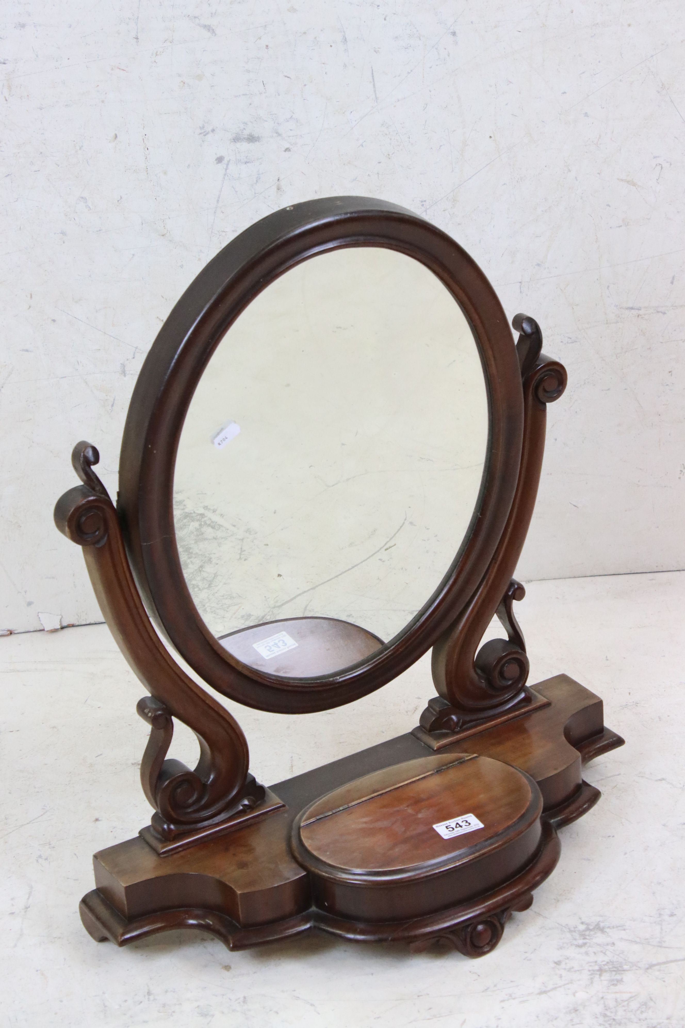Victorian Mahogany Oval Swing Dressing Mirror held on a scrolling carved support and a shaped base