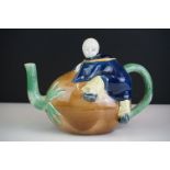 Majolica teapot and cover modelled as a Chinese boy resting on a brown coconut with green glazed
