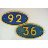 Two painted cast metal signs numbered 36 and 92, of oval form, possibly railway bridge plates,