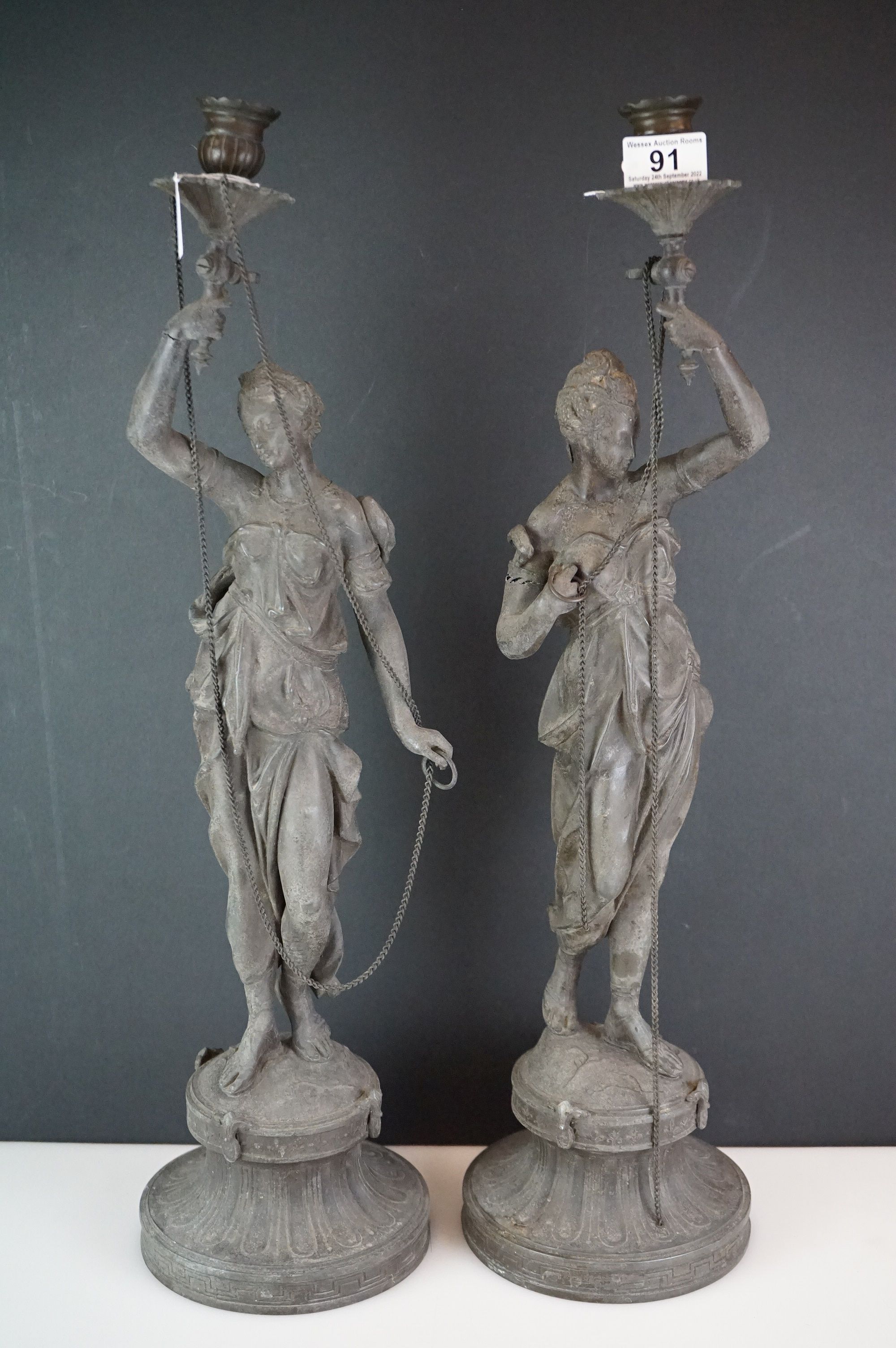 Pair of spelter candlesticks, the stems cast as classical maidens on pedestals, approx 60cm high (