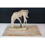 Clay sculpture of a grazing horse, mounted on a wooden base, approx 28cm high