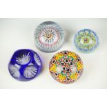 Four glass paperweights to include 3 millefiori examples, featuring a Perthshire paperweight with
