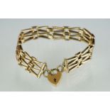 A fully hallmarked ladies 9ct gold gate bracelet with padlock safety chain.