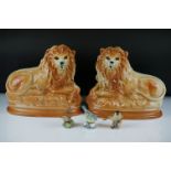 Pair of Staffordshire seated lions with glass eyes, approx 27cm wide, together with three Royal