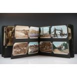An early to mid 20th century photograph album containing mainly topographical photos and postcards.