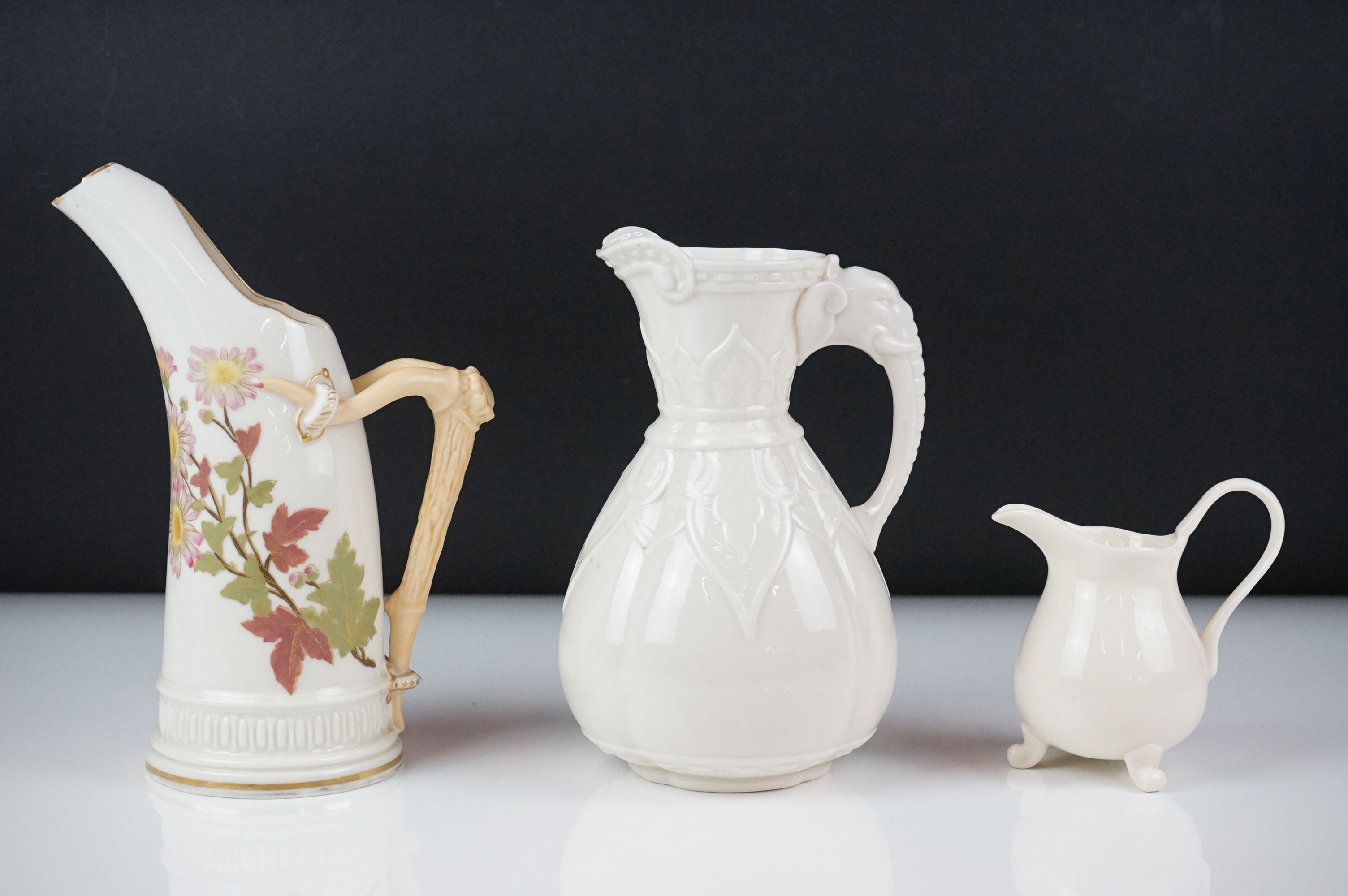 Royal Worcester blush ivory tusk-shaped jug painted with flowers, with gilt borders, 19cm high,