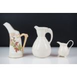 Royal Worcester blush ivory tusk-shaped jug painted with flowers, with gilt borders, 19cm high,