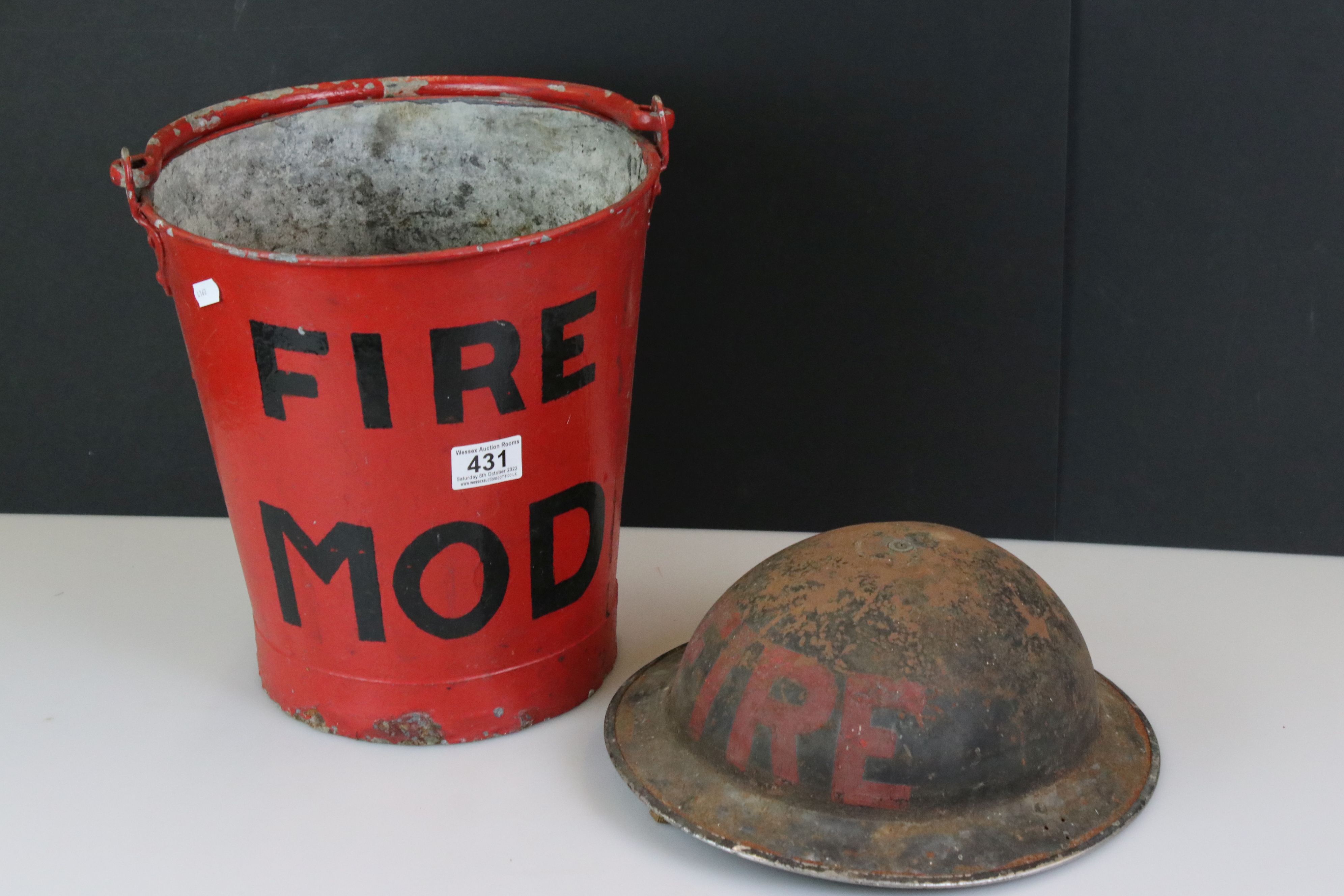 World War II Brodie Fire Helmet together with a Bucket marked Fire MOD